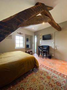 a bedroom with a bed and a table in a room at La Gironnerie in Loché-sur-Indrois