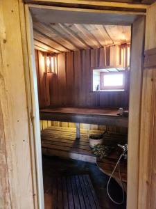 an inside view of a wooden cabin with a window at Pirts māja in Engure