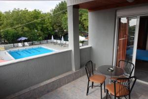 a patio with a table and chairs next to a pool at Camping Mitikas and Bungalows in Plaka Litochorou +43 photos