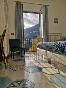 a bedroom with a bed and a window with a view at La Gemma di Ravello in Ravello
