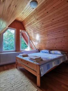 a bedroom with a bed in a wooden cabin at Sanjska Hiša Vojsko in Idrija