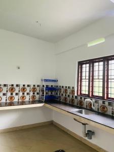 a kitchen with a counter with donuts on the wall at Green Line Homestay in Vythiri