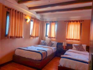 Postel nebo postele na pokoji v ubytování Hotel Garuda