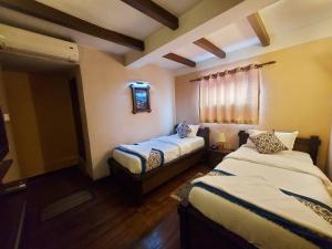 Postel nebo postele na pokoji v ubytování Hotel Garuda