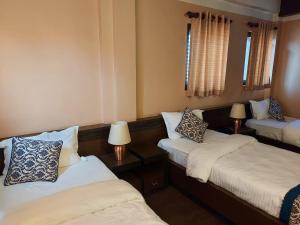 Postel nebo postele na pokoji v ubytování Hotel Garuda