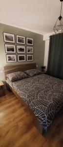 1 cama grande en un dormitorio con cuadros en la pared en Przytulne mieszkanie w Olkuszu/ Cosy apartment in Olkusz, en Olkusz