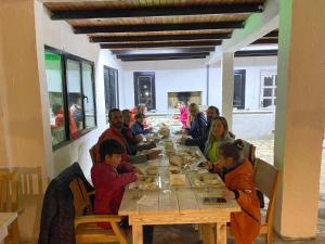 a group of people sitting at a table eating food at KiDRAK OTEL MONTENEGRO-1 in Faralya