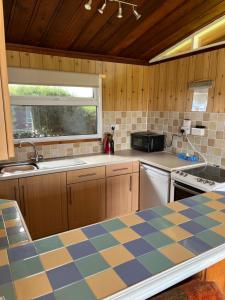 a kitchen with a checkered counter top at Chalet 31 in Seaton