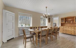 a dining room and kitchen with a table and chairs at Stunning Home In Sydals With Wifi in Skovby