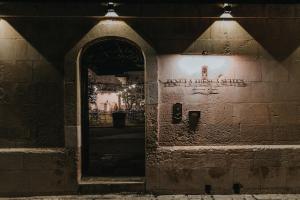 an entrance to a building with an open door at Tenuta Tresca Suites - Dimora Storica in San Cassiano