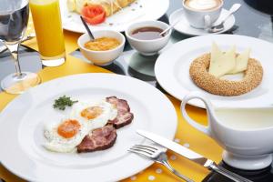 a table with plates of breakfast food on it at Apollon Boutique Hotel in Parikia