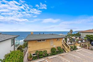 an aerial view of a house with the ocean in the background at Villa Teatro at the Retreat in Laguna Beach in Laguna Beach