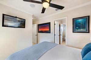 a bedroom with a bed and a ceiling fan at Villa Teatro at the Retreat in Laguna Beach in Laguna Beach
