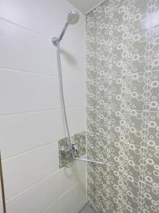 a shower with a glass door in a bathroom at The Top Hostel in Tashkent