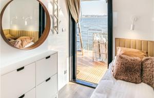 a bedroom with a bed and a mirror on a boat at Beautiful Ship In Neuruppin With Lake View in Neuruppin
