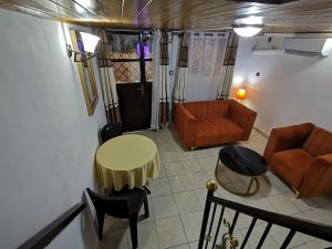 a living room with a couch and a table and chairs at Résidence Hôtelière MB-4D in Douala +47 photos
