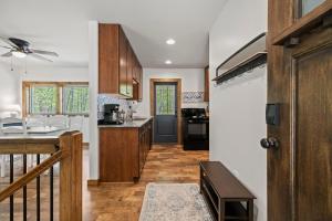 a kitchen with a door leading to a dining room at Serra Stays - "Casa di Cresta" in Lake Lure