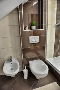 a bathroom with a toilet and a sink at Apartman Harmony in Kastav +38 photos