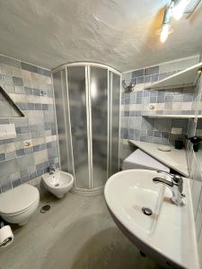 a bathroom with a shower and a toilet and a sink at SAN TEODORO PUNTA EST MONOLOCALE VISTA MARE in Capo Coda Cavallo