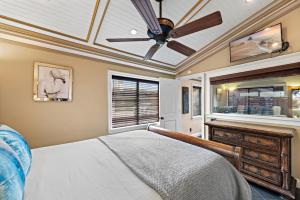 a bedroom with a ceiling fan and a bed at Villa Palazzo D'Stella at the Retreat in Laguna Beach