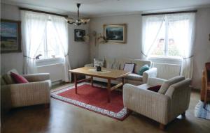 Amazing Home In Vetlanda With Wifi في فيتلاندا: غرفة معيشة مع كنب وطاولة وكراسي
