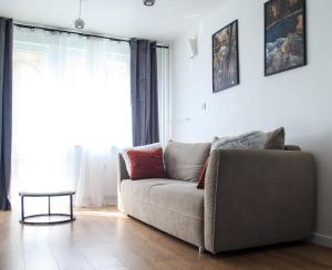 a living room with a couch and a window at Studio dla Dwojga in Sanok