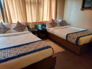Postel nebo postele na pokoji v ubytování Hotel Garuda