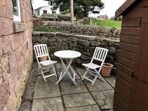 two chairs and a table and a table and two chairs at Charming 1 Bed Peak District Cottage Barn Near Alton Towers, Polar Bears, Chatsworth House in Leek