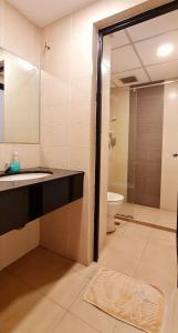 a bathroom with a shower and a sink and a toilet at PP Hotel by Moxy in George Town