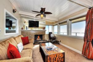 a living room with a couch and a fireplace at Villa Roma at the Retreat in Laguna Beach in Laguna Beach