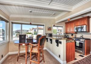 a kitchen with a table and chairs in a room at Villa Roma at the Retreat in Laguna Beach in Laguna Beach