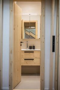 a bathroom with a sink and a mirror at Vila Vlasta Apt. #401 in Starý Smokovec