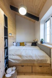 a bedroom with a large bed and a window at Vila Vlasta Apt. #401 in Starý Smokovec