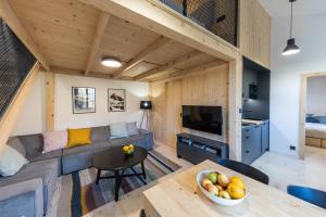 a living room with a couch and a table at Vila Vlasta Apt. #401 in Smokovce