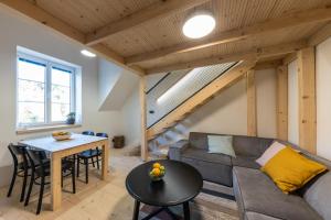 a living room with a couch and a table at Vila Vlasta Apt. #401 in Starý Smokovec