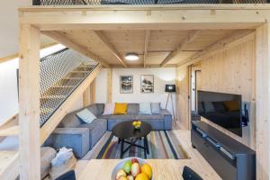 a tiny house with a staircase and a couch at Vila Vlasta Apt. #401 in Starý Smokovec