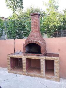 a brick oven sitting on top of a patio at Casa Diana Govora in Prăjila