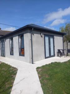 a small house with a picnic table in front of it at Sunny Side - Self Catering Accommodation Gorey in Gorey