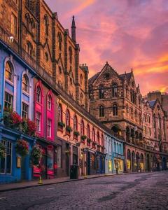 a group of buildings on a street at sunset at The Grove in Edinburgh