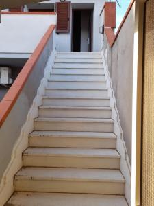 a set of stairs leading up to a building at Appartamento centro in SantʼAntìoco