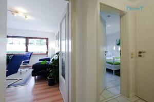 a hallway leading to a living room with a couch at Ferienwohnung Tor zum Spessart in Wächtersbach