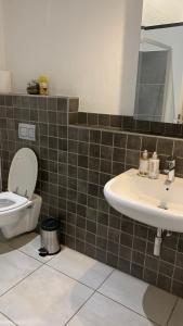 a bathroom with a toilet and a sink at CALDESMO - Upmarket Apartment in Pretoria