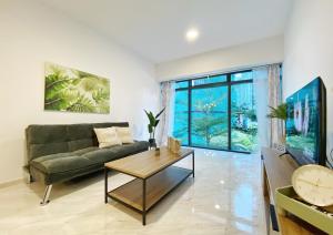 a living room with a couch and a table at Amazing KLCC SKY view infinity pool Eaton Residences Suites in Kuala Lumpur