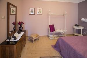 a bedroom with a bed and a dresser and a mirror at C'ERA UNA VOLTA - casa vacanza Etna-Sicilia-mare in Linguaglossa
