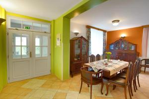 a dining room with a table and some green walls at Pension Harmonie in Hrubá Skála