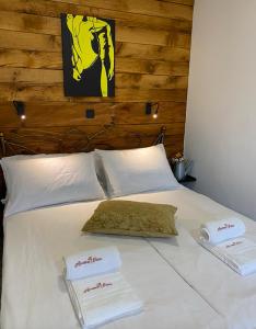 Una cama blanca con dos toallas encima. en Spacious apartment in nature with infrared sauna!, en Postojna