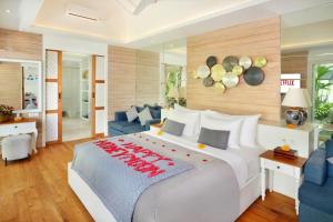 A bed or beds in a room at Aleva Villa Seminyak by Ini Vie Hospitality