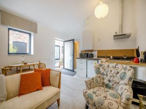 a living room with a couch and a kitchen at Angeliki - Uk43588 in Ellesmere