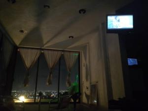 uma televisão numa sala de estar com vista para uma cidade em Loft en Tercer Piso con Vista Panoramica em Puebla