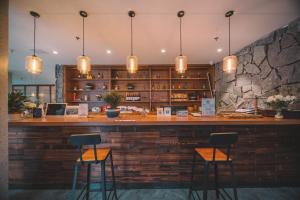 a bar in a restaurant with two stools at Zhangjiajie National Park Nvue Resort Free Laundry & Dry Service,Free Fresh coffee& Customizing Tour Plan in Zhangjiajie